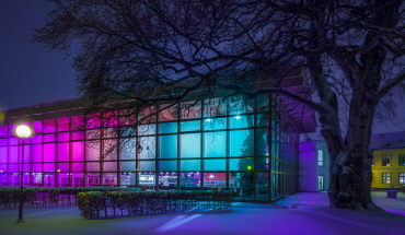 Vinterljus som lyser rosa och blått utanför stadsbibloteket, Foto.